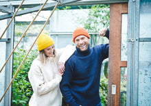 Woman wearing yellow Alpaca Bob Hat Beanie, Man wearing orange Alpaca Bob Hat Beanie