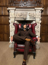 Claudia Winkleman wearing her brown herringbone tweed suit by Barrington Ayre on The Celebrity Traitors